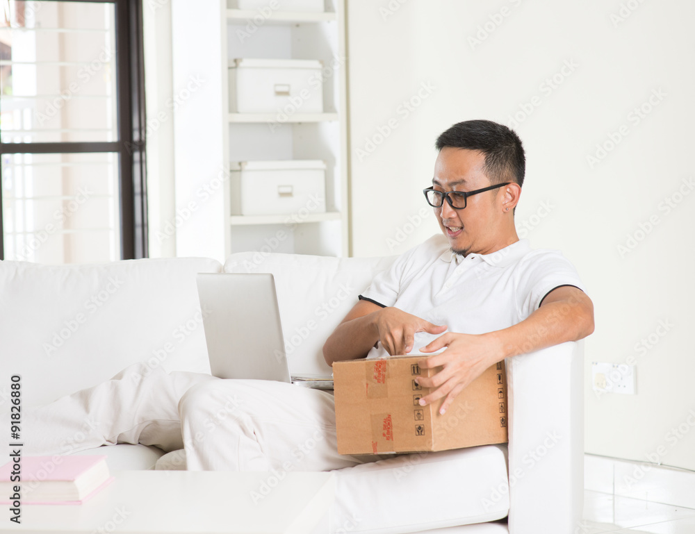 asian male online shopping with parcel received and credit card asian male online shopping with parcel received and credit card