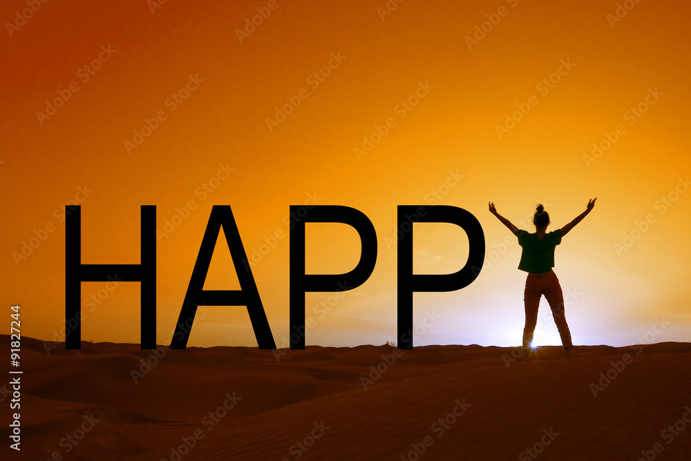 Word happy and silhouette of a woman standing in the sunset Word happy and silhouette of a woman standing in the sunset