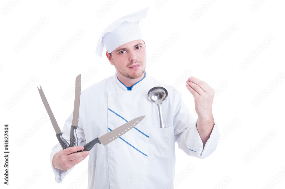 Chef or cook holding professional knives and showing tasty gestu Chef or cook holding professional knives and showing tasty gestu