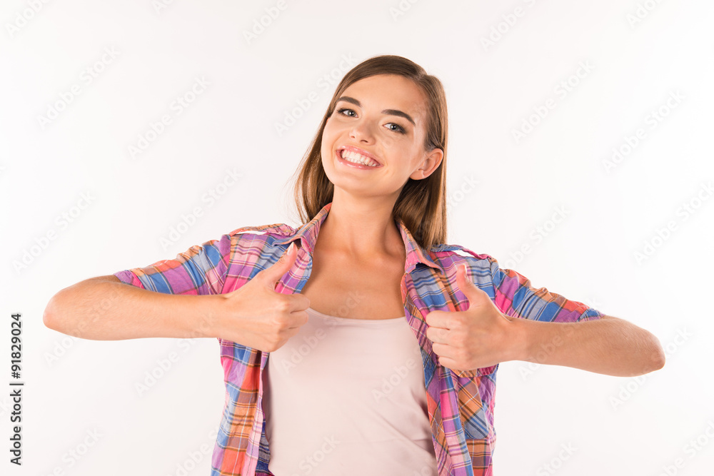 girl showing thumbs up and smiling girl showing thumbs up and smiling