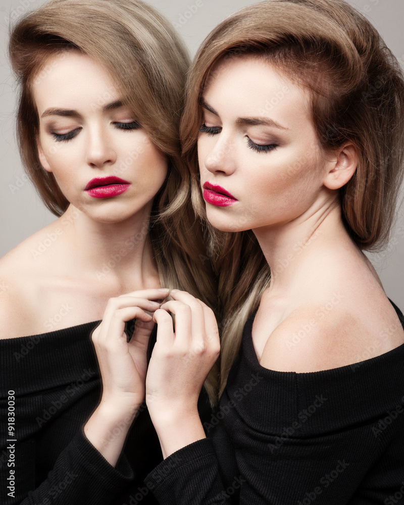 High fashion look.glamour fashion portrait of beautiful sexy brunette girl female model with bright makeup and red lips and her reflection in mirror High fashion look.glamour fashion portrait of beautiful sexy brunette girl female model with bright makeup and red lips and her reflection in mirror