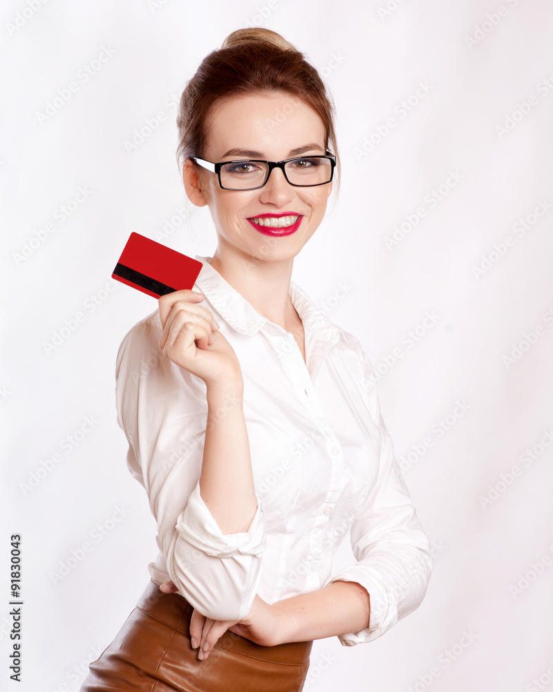 Close-up portrait of young smiling business woman holding credit card isolated on white background Close-up portrait of young smiling business woman holding credit card isolated on white background