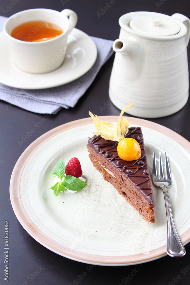 piece of chocolate cake on a white plate decorated with berries piece of chocolate cake on a white plate decorated with berries