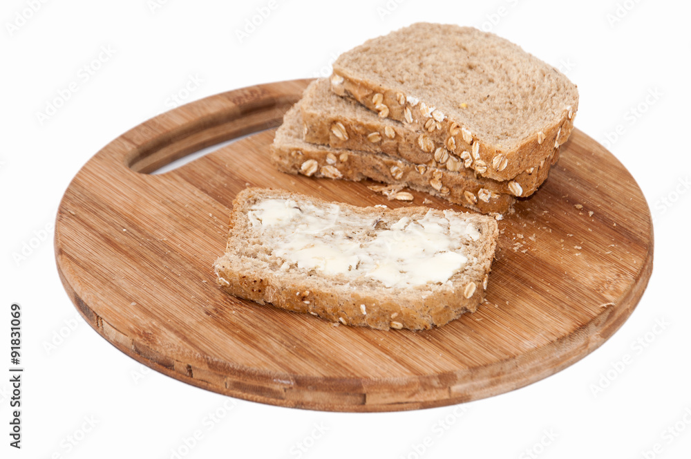Brown bread with seeds coated with butter