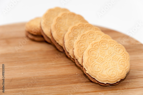 Line chocolate sandwich cookies wooden board