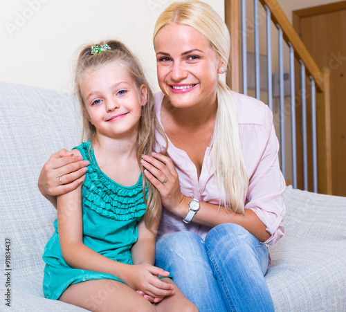 Home portrait of young mother with child. photo