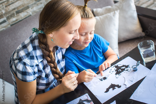 Mom with son draw a flying mouse photo