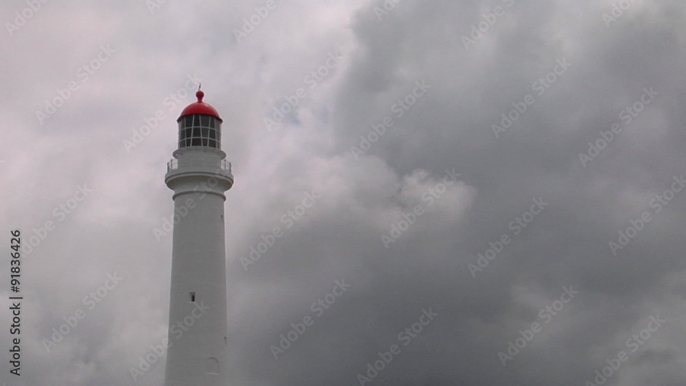 A lighthouse stands ready in the murk of an overcast day. A lighthouse stands ready in the murk of an overcast day.