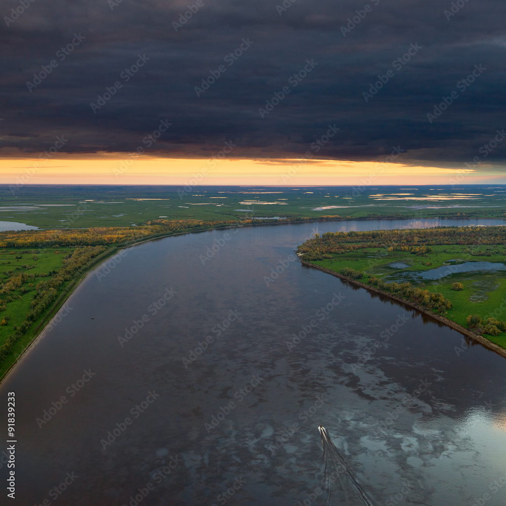 Top view of calm river in autumn evening