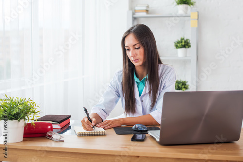 Portrait of physician doctor working in medical office workplace