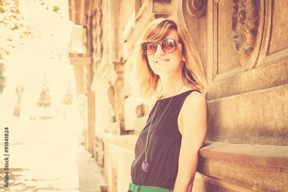 Fototapeta premium Urban girl posing in a classic European street surroundings.