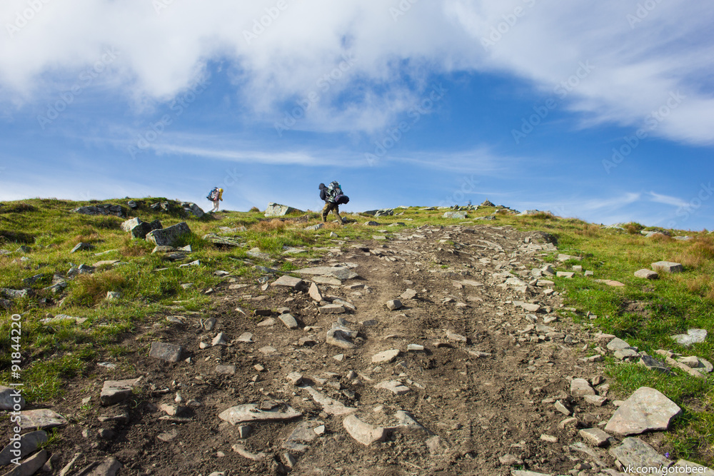 Two guys climbers climb to the summit of Mount Hoverla