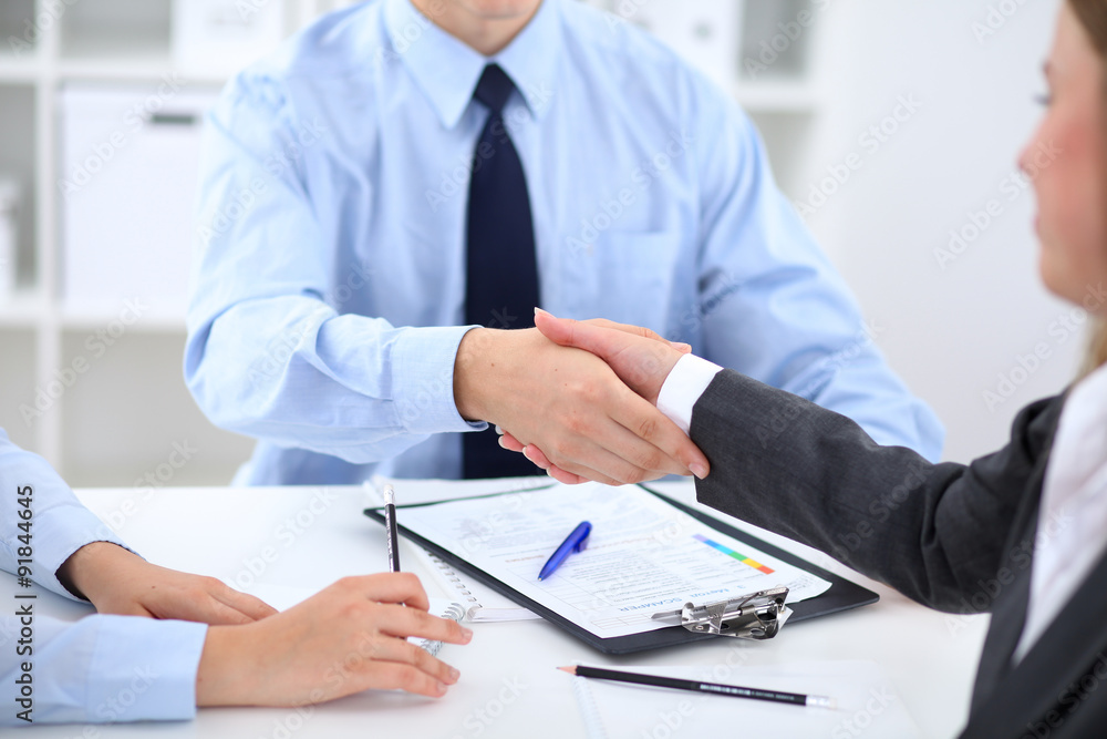 Business people shaking hands, finishing up a meeting Business people shaking hands, finishing up a meeting