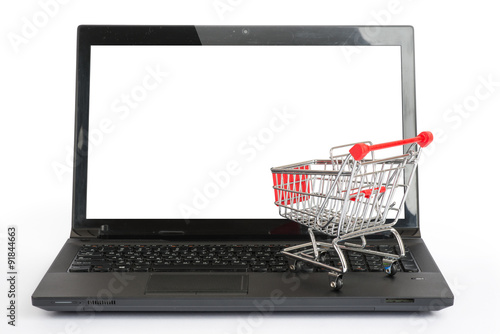 Shopping cart on laptop, front view