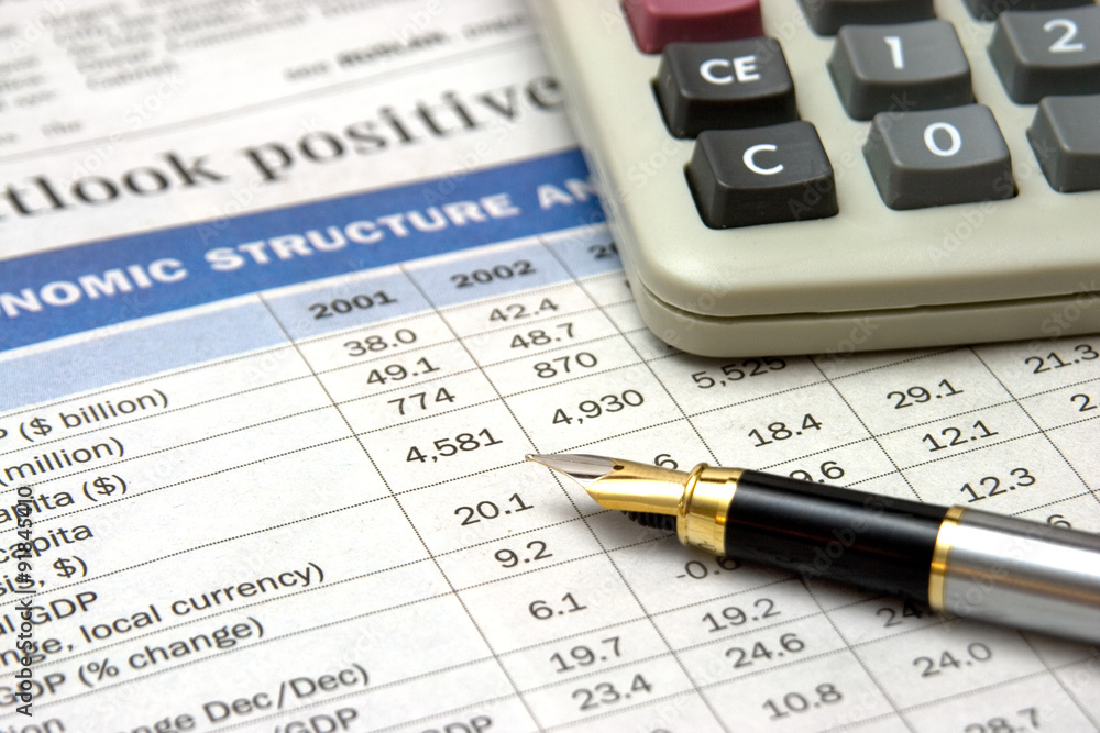 calculator and pen on business report
calculator and pen on business report