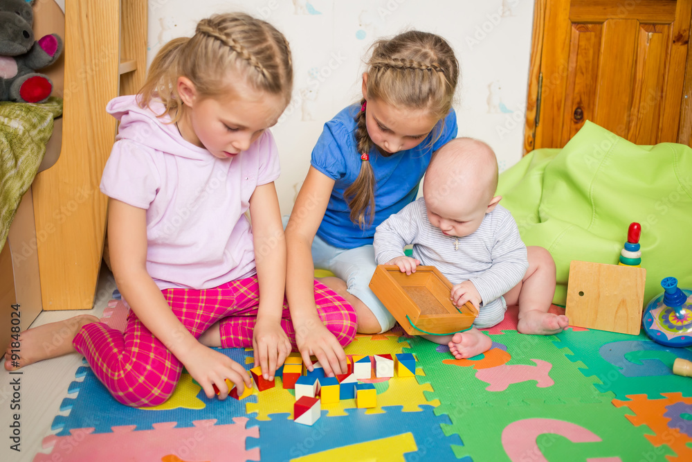 Fototapeta premium Happy kids playing with little brother