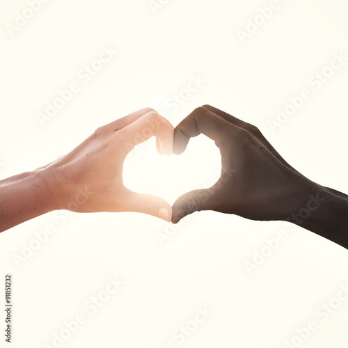 interracial couple in love heart shape hand gesture
