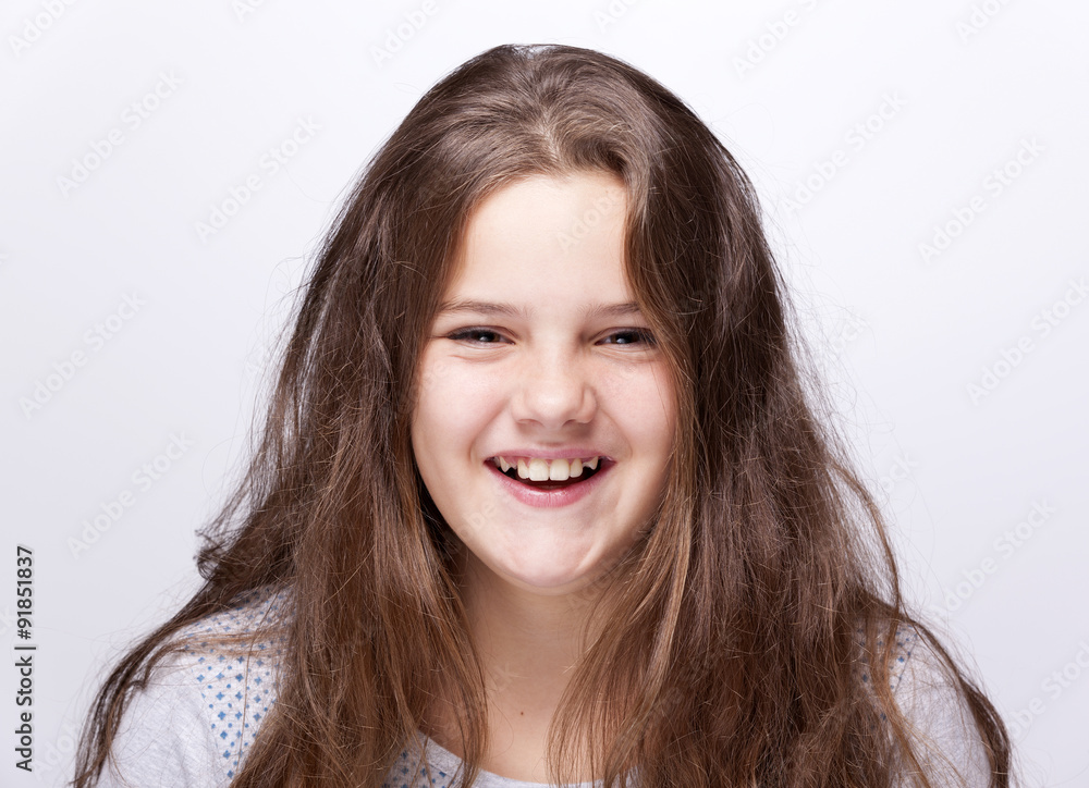 Portrait of a teenager girl laughing on gray background Portrait of a teenager girl laughing on gray background