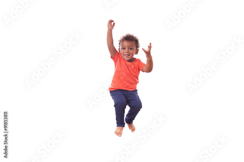 Photos Portrait of a cute little African American boy jumping on a tram