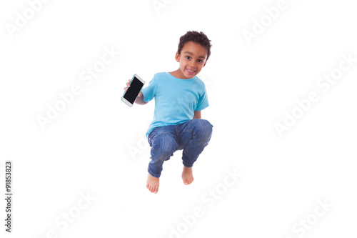 Portrait of a cute little African American boy jumping on a tram