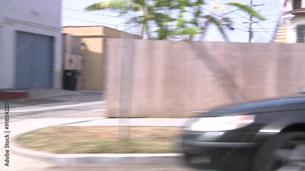 A car travels along a street in Santa Monica, California as seen through the side window. A car travels along a street in Santa Monica, California as seen through the side window.