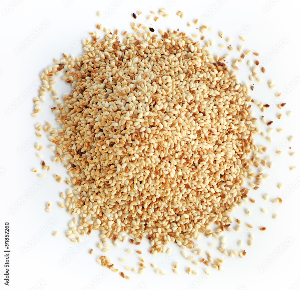 Heap of organic natural sesame seeds over white background Heap of organic natural sesame seeds over white background