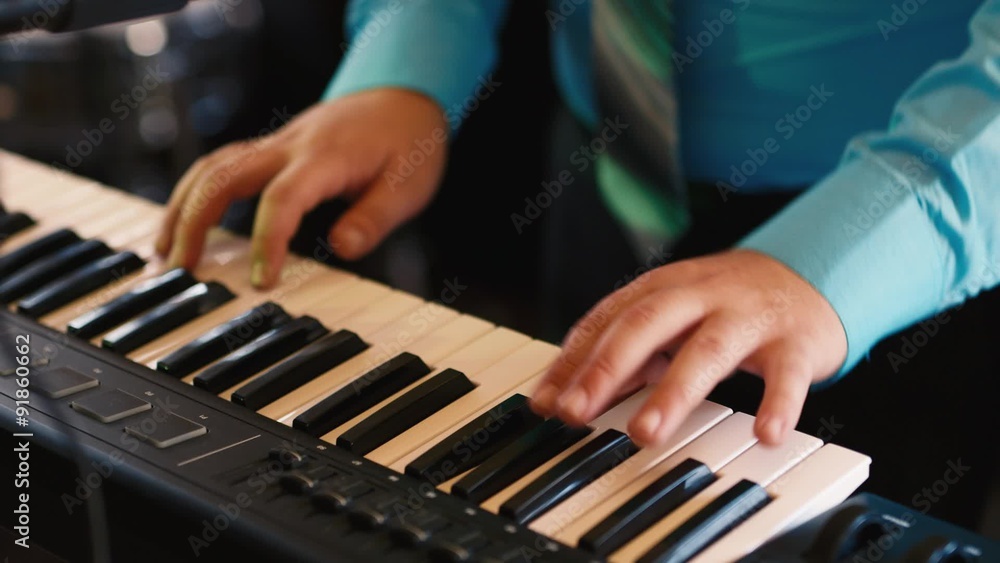 Hands of the musician playing on a synthesizer, an electronic Hands of the musician playing on a synthesizer, an electronic