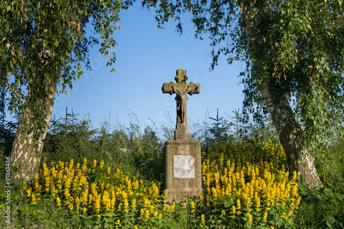 Stone cross near road