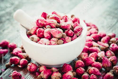 Mortar with rose buds. Selective focus. photo