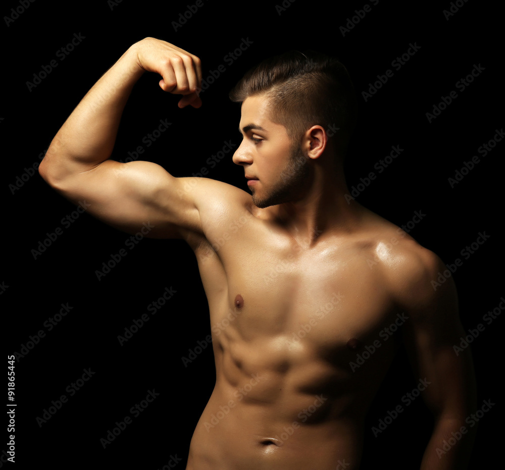 Muscle young man on dark background