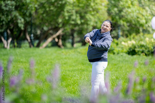 Senior woman doing exercises in green beautiful park. Healthy lifestyle © Suzi Media 