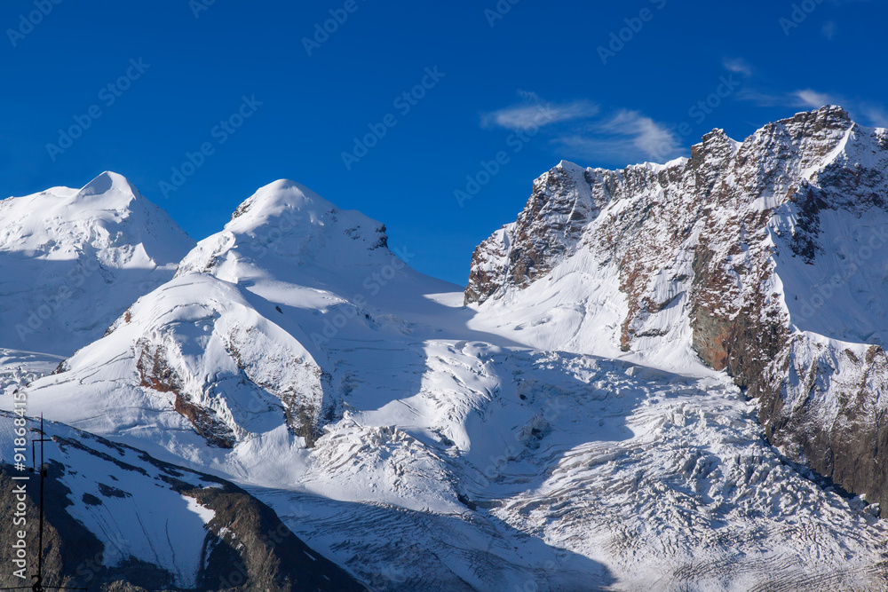 Swiss Alps with glaciers against blue sky
