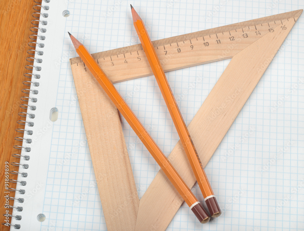 Notebook with pencils and triangle Notebook with pencils and triangle