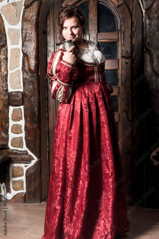 Beautiful woman in red dress in retro baroque style