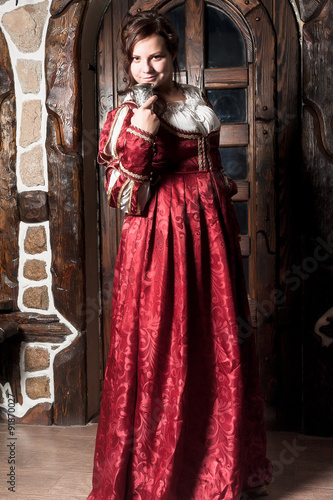 Beautiful woman in red dress in retro baroque style