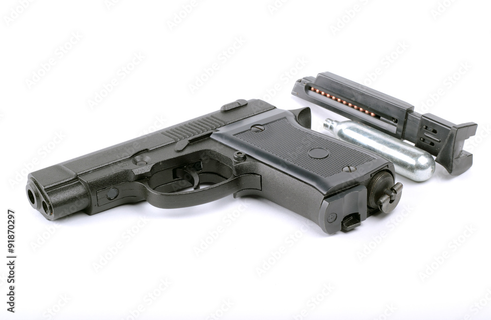 Black pneumatic pistol with a gas cylinder and a charger  isolated on white background