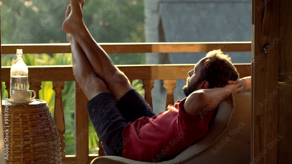 Young man relaxing and sleeping on terrace