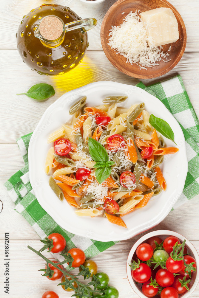 Colorful penne pasta with tomatoes and basil Colorful penne pasta with tomatoes and basil