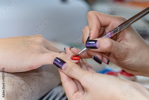 painting nails in nail salon  UV lap of quick dry nail polish ma