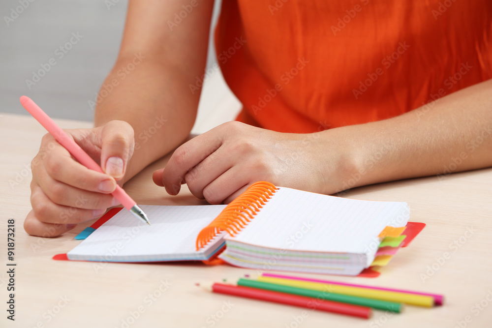 Woman write on notebook on workplace close up Woman write on notebook on workplace close up
