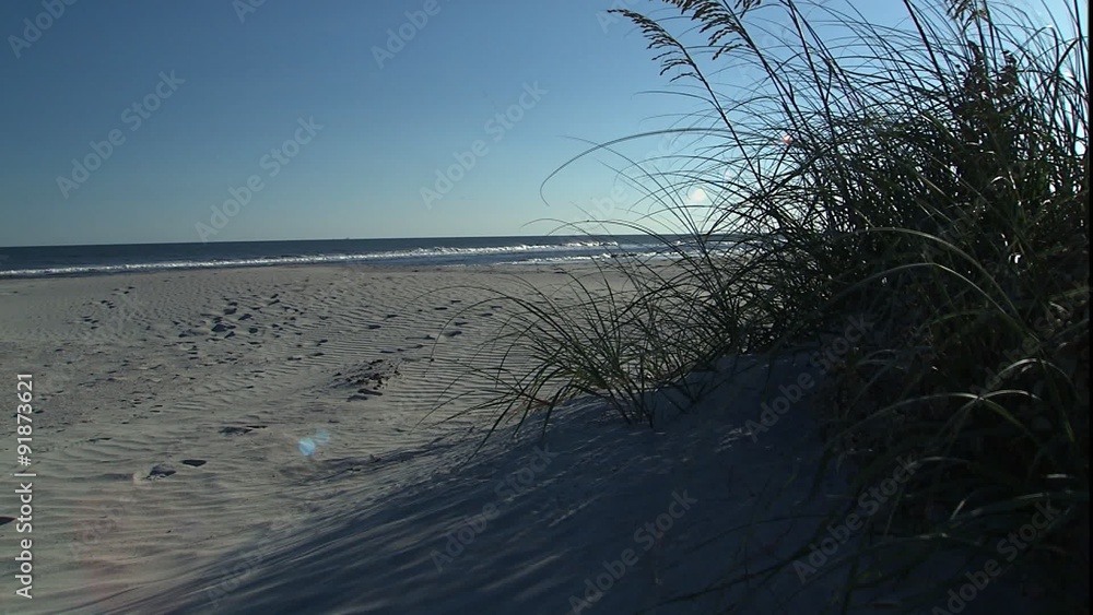 Jib up revealing WS of beach & kite boarder Jib up revealing WS of beach & kite boarder
