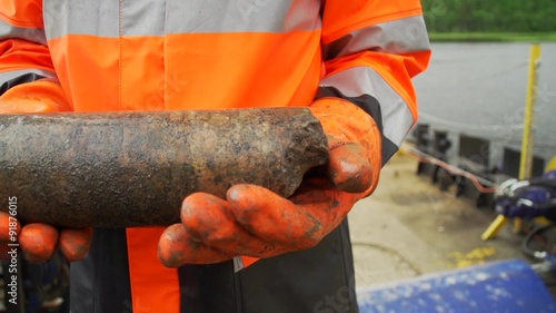 geologist hold drilled granite core