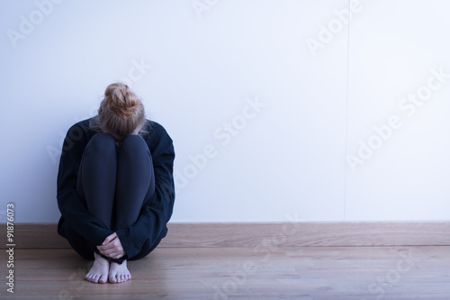 Woman sitting curled up