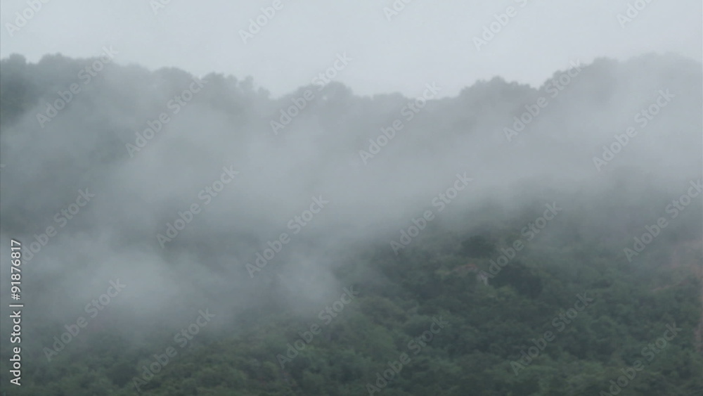 Fog rolls across a mountaintop. Fog rolls across a mountaintop.