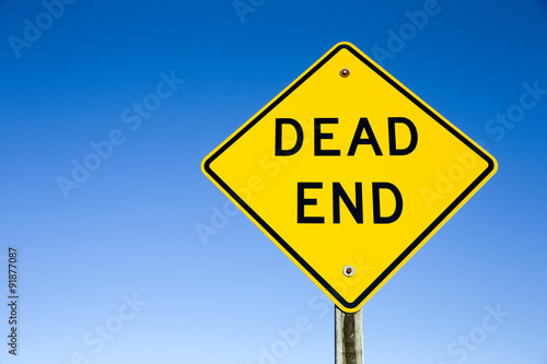 Dead End Sign Against Blue Sky photo