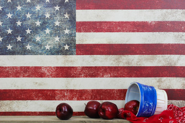 Basket of red apples with handkerchief by vintage American flag background