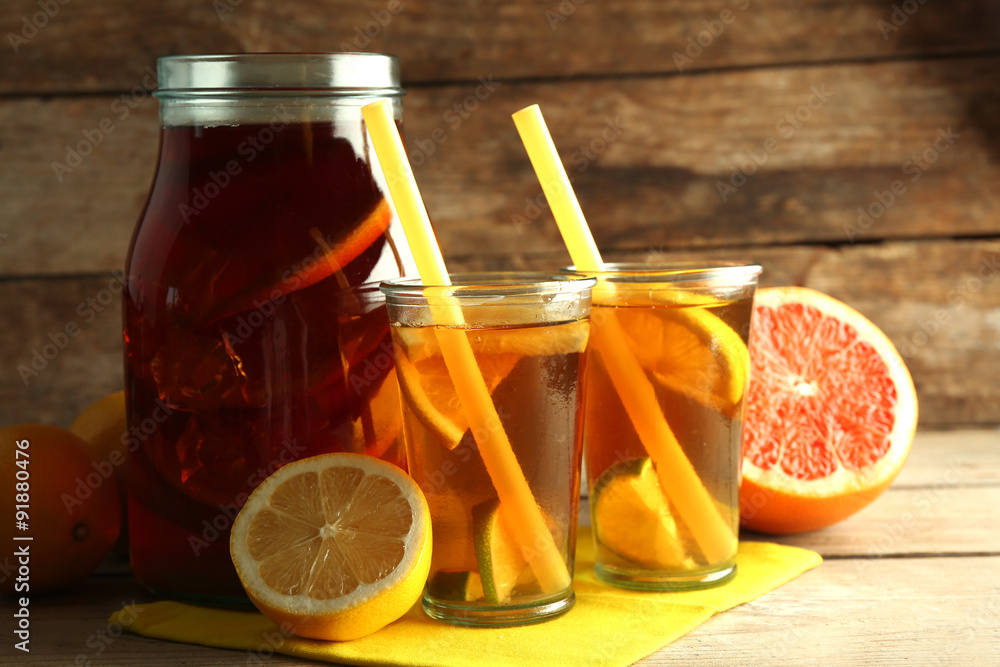 Iced tea with lemon and grapefruit on wooden background Iced tea with lemon and grapefruit on wooden background