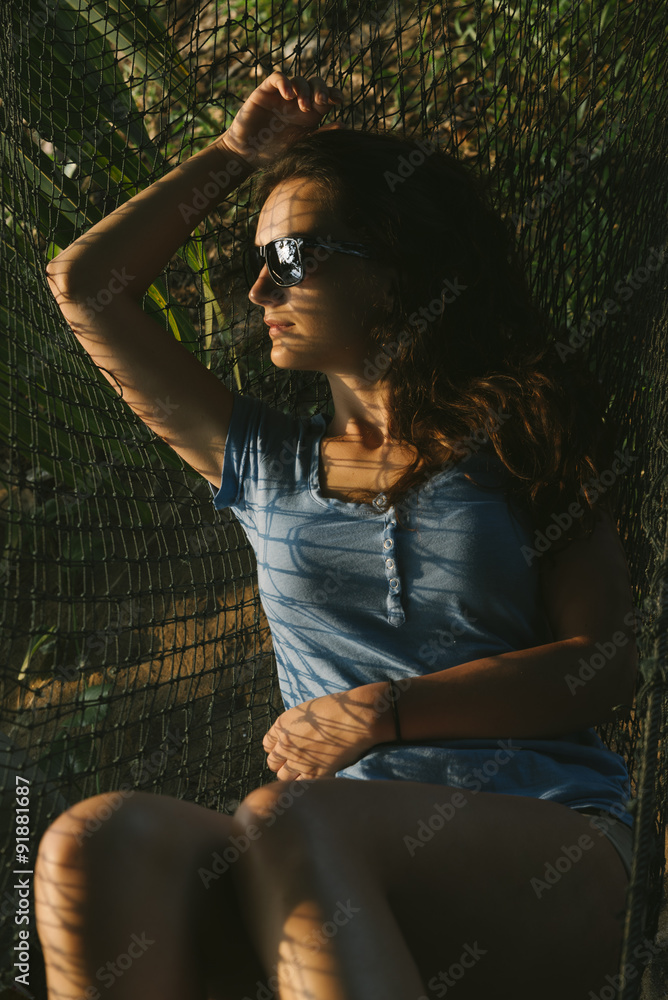 Obraz premium Beautiful woman lying in hammock.