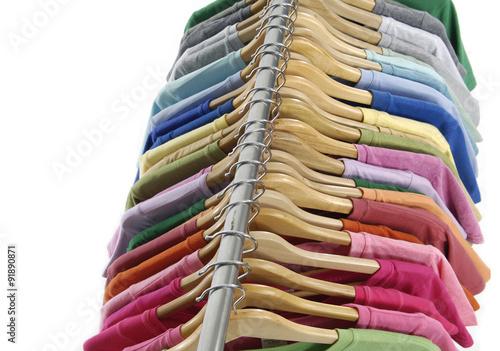 Set of Choice of man clothes of different colors on wooden hangers 