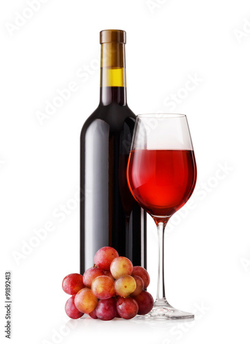 Glass and bottle of red wine with grapes